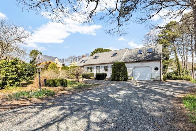 67 Whippoorwill Cir, Mashpee, MA 02649 - view of front of property with a garage, gravel driveway, and a chimney