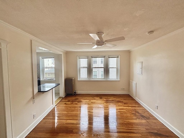 8 Walnut St Unit 8, Everett, MA 02149 - empty room with radiator heating unit, crown molding, a textured ceiling, wood finished floors, and a ceiling fan