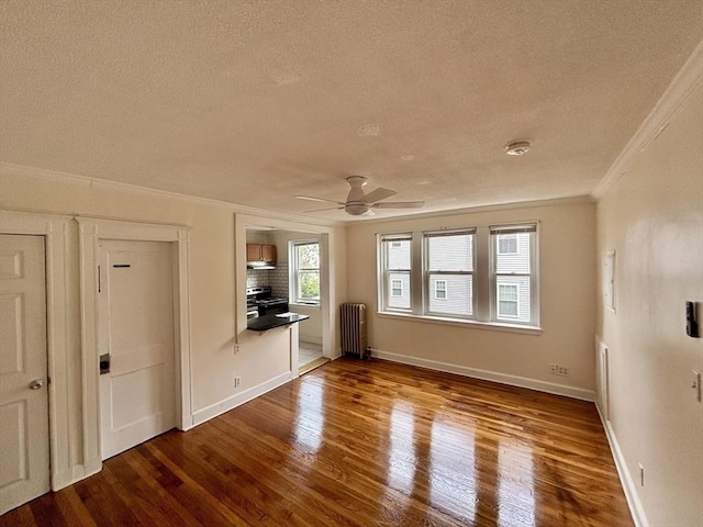 8 Walnut St Unit 8, Everett, MA 02149 - unfurnished living room with a textured ceiling, ornamental molding, wood finished floors, radiator, and ceiling fan