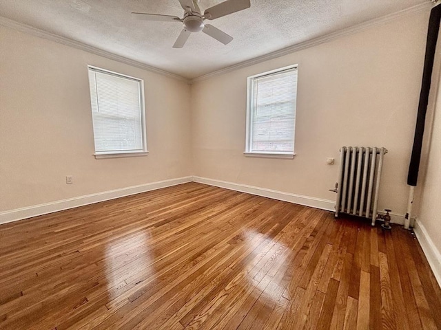 8 Walnut St Unit 8, Everett, MA 02149 - spare room featuring radiator heating unit, hardwood / wood-style flooring, crown molding, a ceiling fan, and a textured ceiling