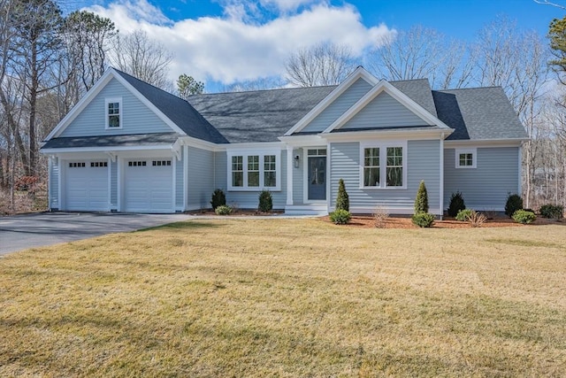 view of front of property with a garage, driveway, a front lawn, and a shingled roof