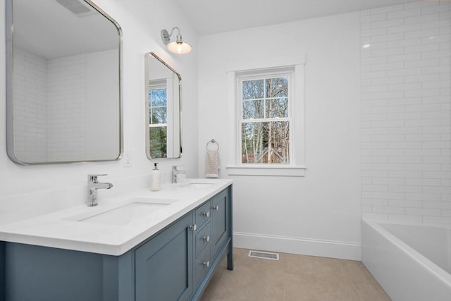 full bathroom featuring double vanity, a sink, visible vents, and baseboards