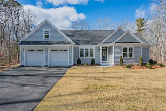 view of front of property with aphalt driveway, a front yard, roof with shingles, and an attached garage