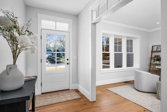 entryway featuring recessed lighting, visible vents, light wood-style flooring, ornamental molding, and baseboards