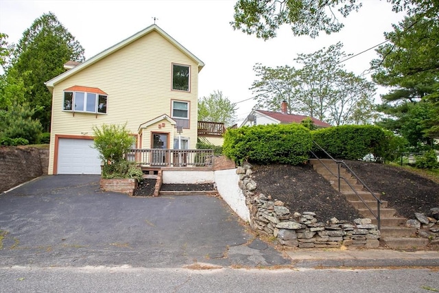 22 Everton Ave, Worcester, MA 01604 - view of front of house with a garage, asphalt driveway, a wooden deck, and stairway