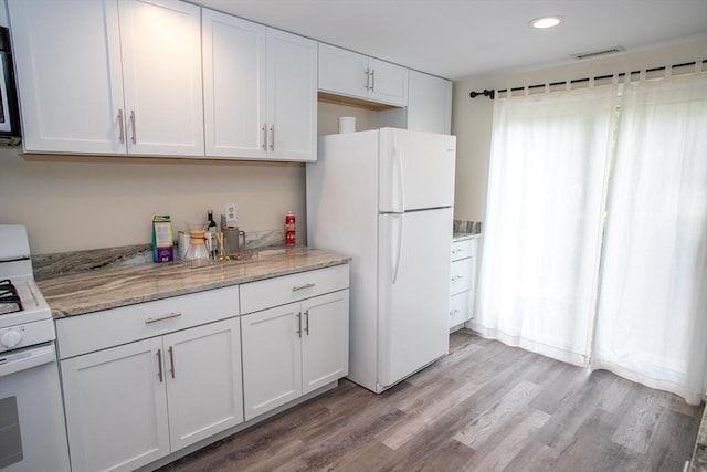 22 Everton Ave, Worcester, MA 01604 - kitchen featuring white appliances, white cabinetry, light wood-style flooring, recessed lighting, and light stone counters