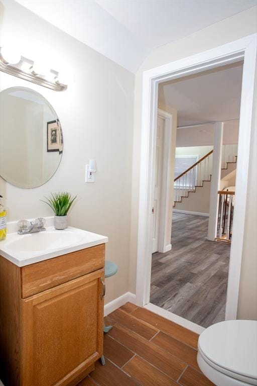 22 Everton Ave, Worcester, MA 01604 - half bathroom with vanity, wood finished floors, toilet, and baseboards