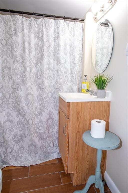 22 Everton Ave, Worcester, MA 01604 - full bath featuring wood finished floors, vanity, toilet, and curtained shower