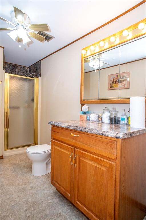 22 Everton Ave, Worcester, MA 01604 - full bathroom with a stall shower, vanity, toilet, and ornamental molding