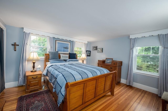 203 Pond St, Weymouth, MA 02190 - bedroom with baseboards, light wood-type flooring, and multiple windows