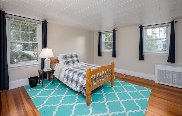 203 Pond St, Weymouth, MA 02190 - bedroom featuring radiator heating unit, baseboards, and wood finished floors