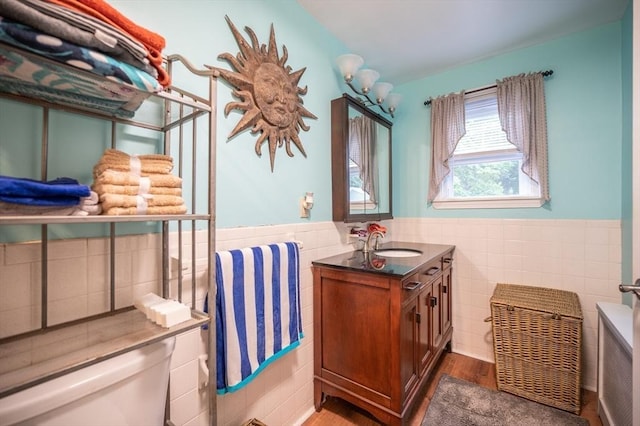 203 Pond St, Weymouth, MA 02190 - bathroom featuring tile walls, wainscoting, wood finished floors, and vanity
