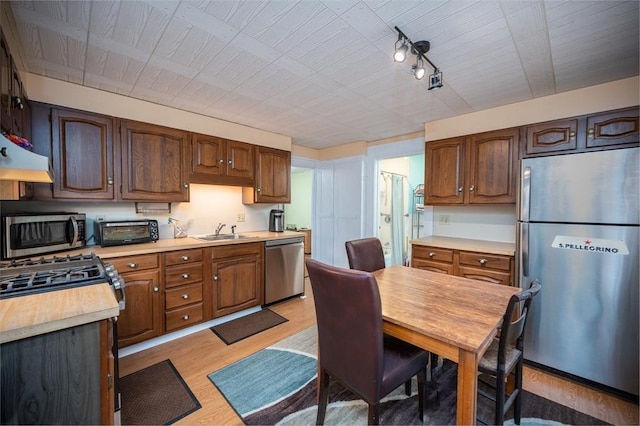 203 Pond St, Weymouth, MA 02190 - kitchen featuring stainless steel appliances, a sink, light wood-style flooring, and light countertops