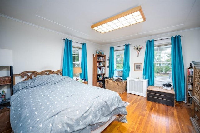 203 Pond St, Weymouth, MA 02190 - bedroom featuring radiator heating unit, wood finished floors, and crown molding