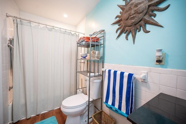 203 Pond St, Weymouth, MA 02190 - full bath featuring toilet, wood finished floors, tile walls, a wainscoted wall, and shower / bathtub combination with curtain