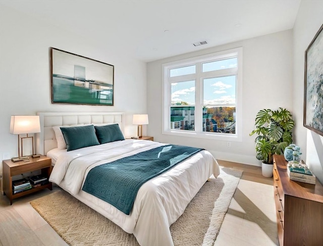 bedroom featuring baseboards and light wood-style flooring