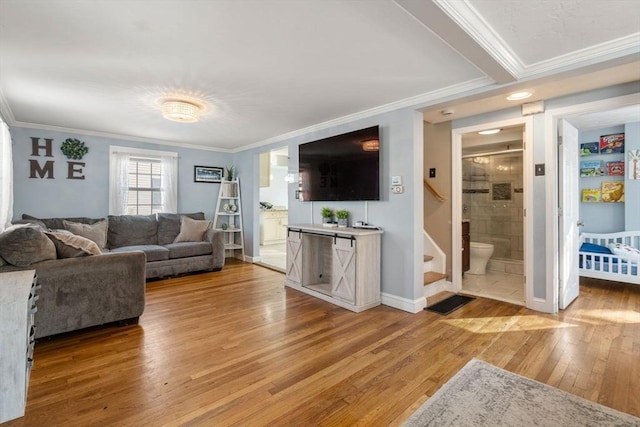 living room featuring hardwood / wood-style floors and crown molding