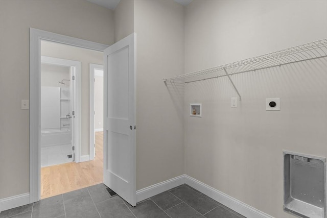 laundry room with hookup for a washing machine, tile patterned floors, and hookup for an electric dryer