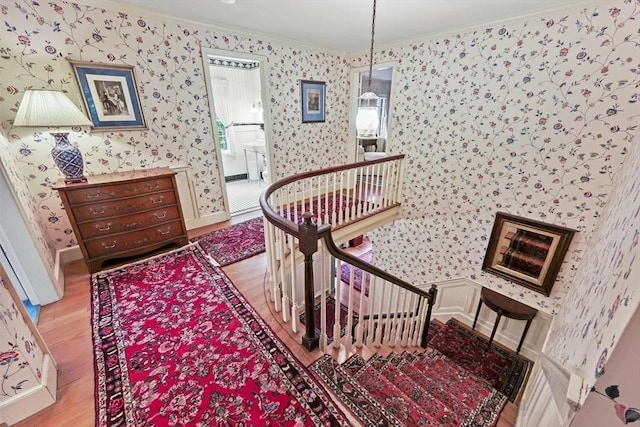 84 Englewood Rd, Longmeadow, MA 01106 - staircase with ornamental molding, wallpapered walls, wood finished floors, and baseboards