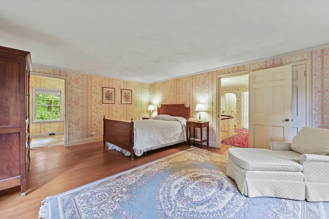 84 Englewood Rd, Longmeadow, MA 01106 - bedroom featuring wallpapered walls, light wood finished floors, baseboards, ornamental molding, and connected bathroom