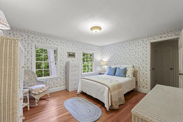 84 Englewood Rd, Longmeadow, MA 01106 - bedroom with wallpapered walls, wood finished floors, and baseboards