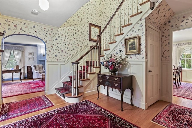 84 Englewood Rd, Longmeadow, MA 01106 - foyer entrance with wallpapered walls, crown molding, wood finished floors, a wainscoted wall, and stairs