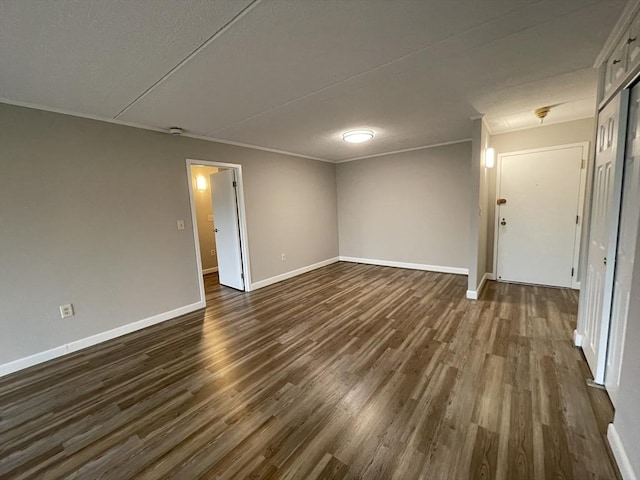 1550 Worcester Rd Unit 524, Framingham, MA 01702 - spare room with dark wood-style flooring, baseboards, and crown molding