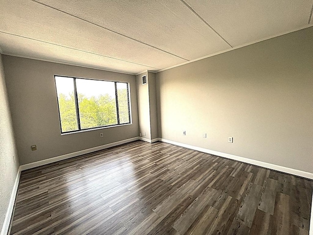 1550 Worcester Rd Unit 524, Framingham, MA 01702 - unfurnished room featuring dark wood-style floors, baseboards, and a textured ceiling