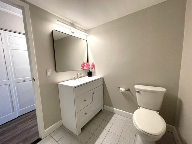 1550 Worcester Rd Unit 524, Framingham, MA 01702 - bathroom featuring toilet, vanity, baseboards, and tile patterned floors