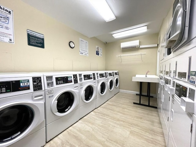 1550 Worcester Rd Unit 524, Framingham, MA 01702 - community laundry featuring estacked washer and dryer, a wall unit AC, washing machine and dryer, and baseboards