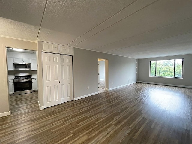 1550 Worcester Rd Unit 524, Framingham, MA 01702 - unfurnished living room with dark wood-style floors, baseboards, and a textured ceiling