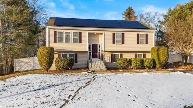 bi-level home featuring solar panels