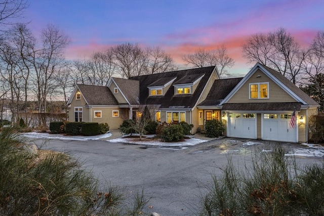 cape cod-style house featuring a garage