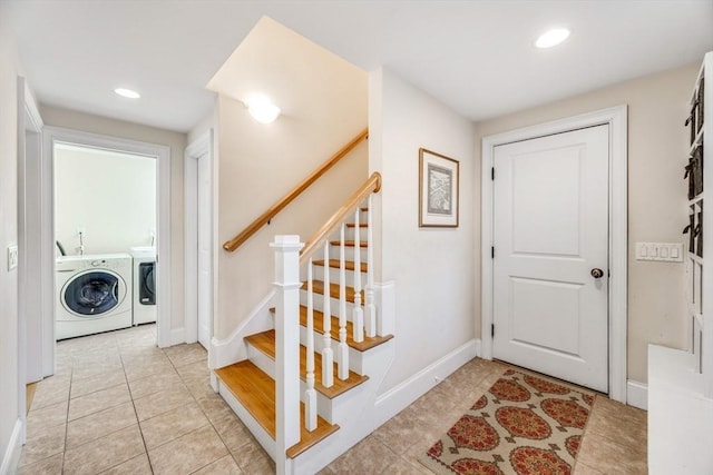 foyer with washer and dryer and light tile patterned floors