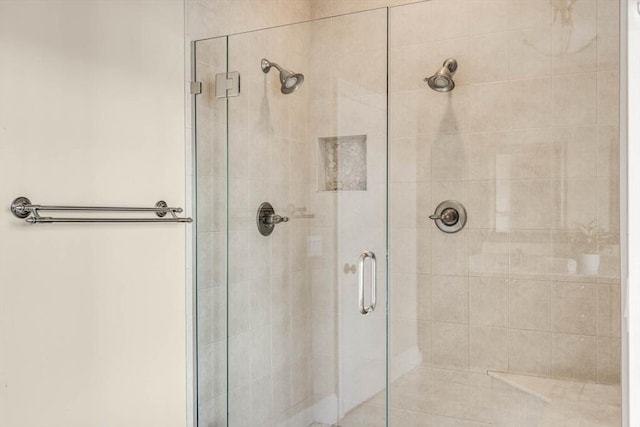 bathroom featuring a shower with shower door