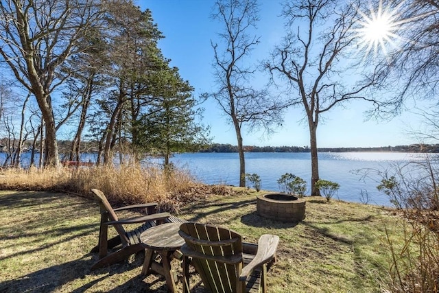 view of yard featuring a water view and a fire pit