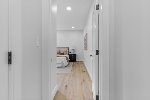 hallway with light hardwood / wood-style flooring