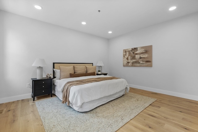 bedroom with hardwood / wood-style floors