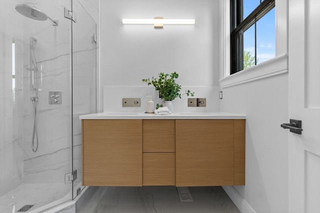 bathroom with a shower with door and vanity