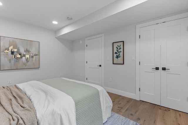 bedroom with a closet and hardwood / wood-style floors