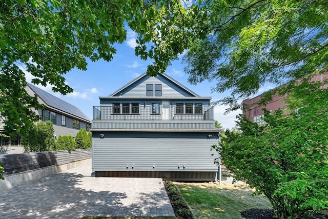 rear view of property featuring a balcony