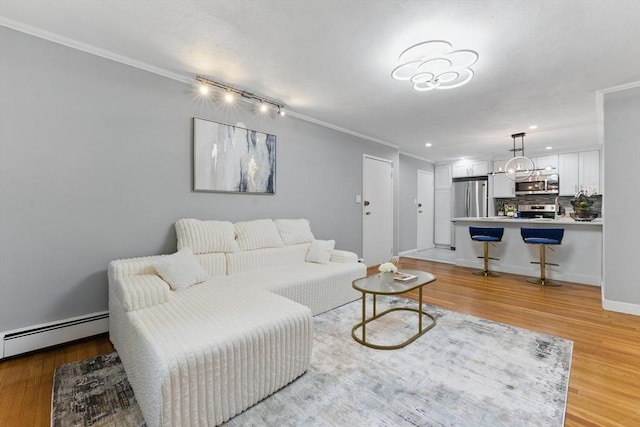 12 Riverside St Unit 1-3, Watertown, MA 02472 - living room featuring crown molding, a baseboard heating unit, light wood finished floors, recessed lighting, and baseboards