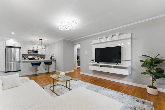 12 Riverside St Unit 1-3, Watertown, MA 02472 - living room with a chandelier, baseboards, ornamental molding, recessed lighting, and wood finished floors