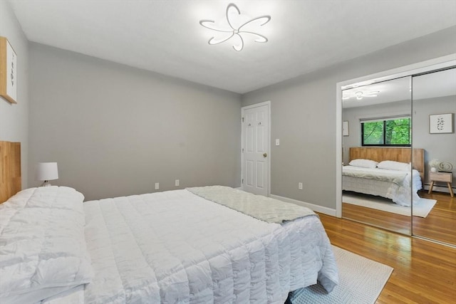 12 Riverside St Unit 1-3, Watertown, MA 02472 - bedroom with wood finished floors, baseboard heating, a closet, and baseboards