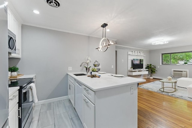 12 Riverside St Unit 1-3, Watertown, MA 02472 - kitchen featuring appliances with stainless steel finishes, a sink, a peninsula, open floor plan, and white cabinetry