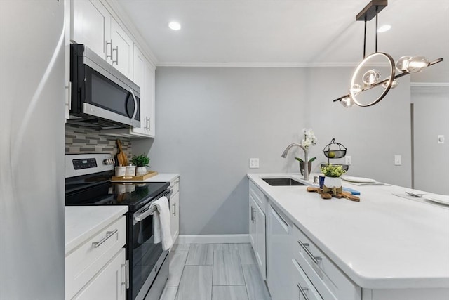 12 Riverside St Unit 1-3, Watertown, MA 02472 - kitchen with stainless steel appliances, a sink, a peninsula, ornamental molding, and tasteful backsplash