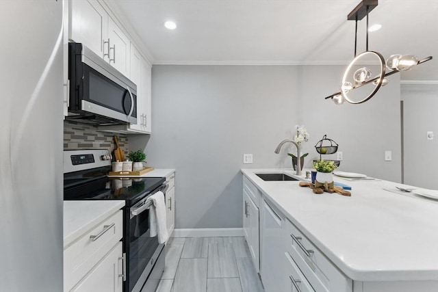 12 Riverside St Unit 1-3, Watertown, MA 02472 - kitchen with stainless steel appliances, a sink, a peninsula, ornamental molding, and backsplash