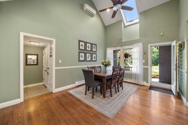 1 Liberty Ln, North Reading, MA 01864 - dining area featuring baseboard heating, a skylight, high vaulted ceiling, wood finished floors, and a ceiling fan