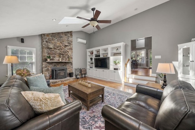 1 Liberty Ln, North Reading, MA 01864 - living room featuring healthy amount of natural light, light wood-style flooring, a ceiling fan, high vaulted ceiling, and a wall mounted AC