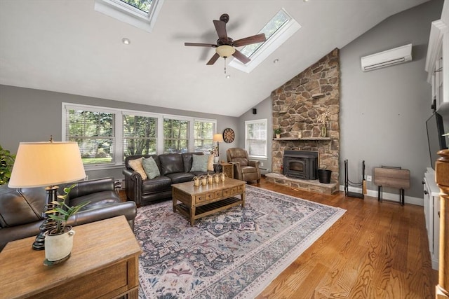 1 Liberty Ln, North Reading, MA 01864 - living room featuring a skylight, a wall mounted air conditioner, wood finished floors, a ceiling fan, and high vaulted ceiling